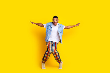 Full size photo of impressed man dressed denim vest dancing hold arms like wings having fun...