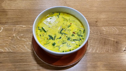 A bowl of soup on a wooden table, showcasing delicious food Hanover Germany