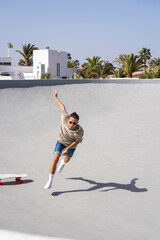 Young Man Performing a Trick on a Surfskate at a Skatepark