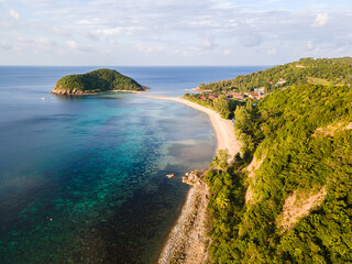 Aerial drone view of a coastline in Koh Phangan Thailand with a small island and beaches