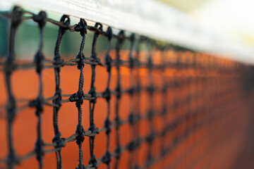 selective focus of tennis net in orange clay court, tennis compettion concept