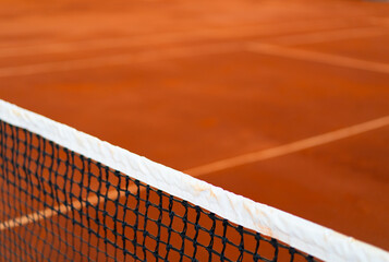 diagonal net of tennis with white stripe in orange clay court, tennis compettion concept