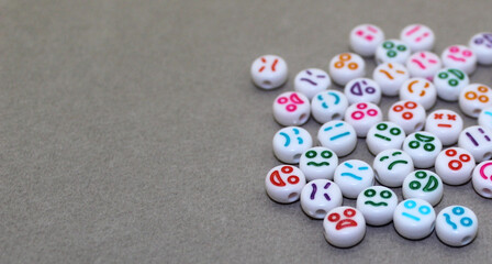 Decorative plastic beads with funny faces. White decorative stones for the necklace.	