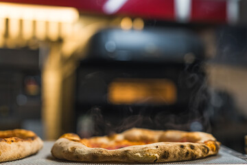 pizza with steam rising from it, kitchen background, delicious italian cuisine. High quality photo