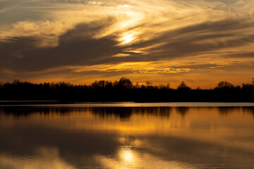 The sky and the lake are red-tinged during sunset