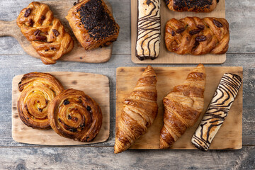 Set of bakery pastries on wooden table. Top view