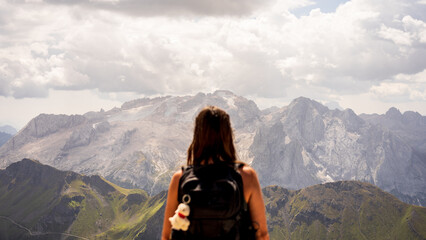 Backpacker woman at the top of the mountain contemplating the immensity
