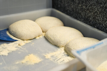 several pizza dough balls together in the kitchen, preparing italian dishes. High quality photo