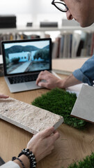 Interior architect working in the office with plans and materials.