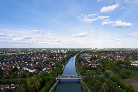 Aerial view of a river with trees, bridge, and urban design Mittellandkanal Seelze Hanover Germany