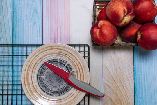 Top view of a basket of pelones, plate and knife.