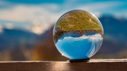 Crystal ball alpine landscape shot with the Geislerspitzen mountains, dolomites, in the background...