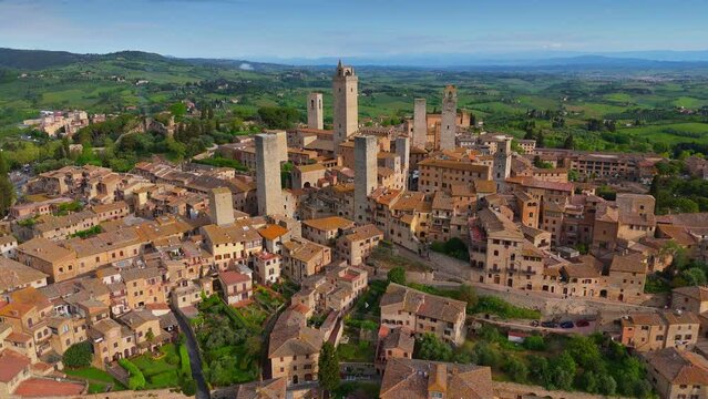 Fly around old town of San Gimignano, Tuscany, Italy. Aerial shot, old stone houses and tower in San Gimignano, Unesco World Heritage Site