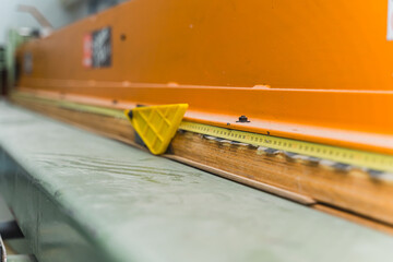 measuring tape sticked on the wood at the workshop, working on wood. High quality photo