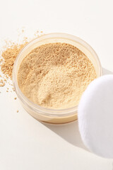 Face powder, light shade on a light background.