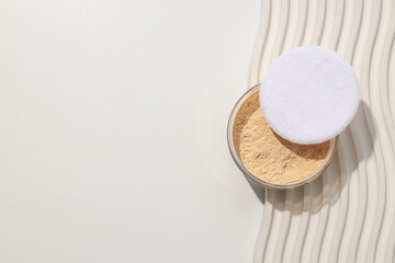 Face powder, light shade on a light background.