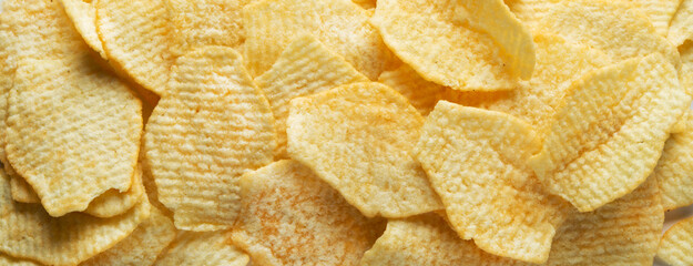 Potato fluted chips. Food background.
