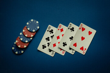 Luck in a casino game with a winning combination of two pairs. Playing cards and chips are laid out in a poker club on a blue table