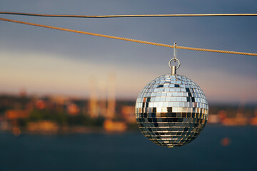 A disco ball hanging over a city