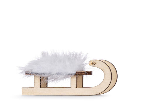 Litte wooden sleigh standing side ways. isolated on a white background.