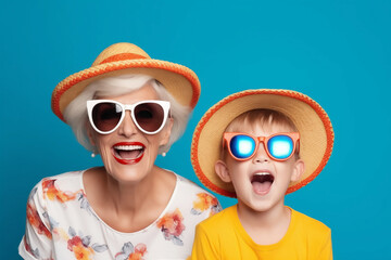 Happy Grandmother and Grandson with Summer Hats and Sunglasses on Blue Background