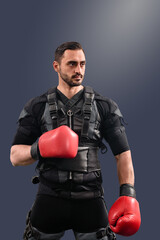 Portrait of strong male boxer having electro muscular stimulation training, Workout regimen: Studio shot of male with electro muscle stimulator, suitable for fitness brochures