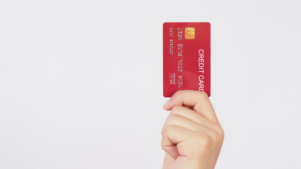 Hand is hold red credit card on white background.