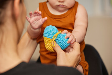 Mom plays with her newborn baby. Close-up