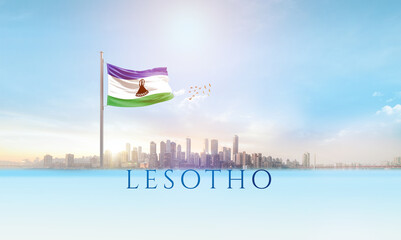 Lesotho national flag waving in beautiful building skyline.