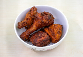 Delicious homemade fried chicken in a white bowl. Bangladeshi authentic Chinese restaurant-style chicken fry.