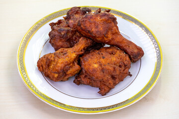 Delicious fried chicken on a white plate. Bangladeshi Chinese restaurant-style chicken fry.