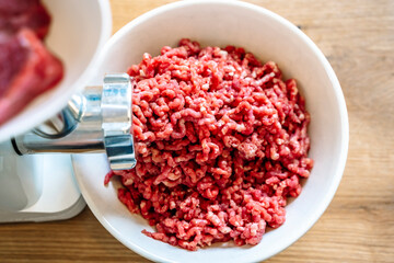 Minced meat and electric meat grinder. Cooking beef minced in the kitchen with an electric grinder