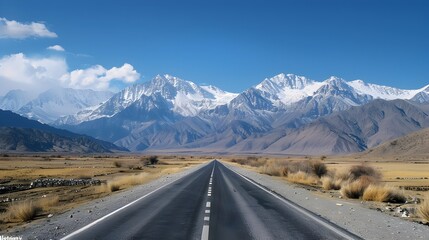 Lone Car on Winding Mountain Road Amid Majestic Snow Capped Peaks and Serene Skies