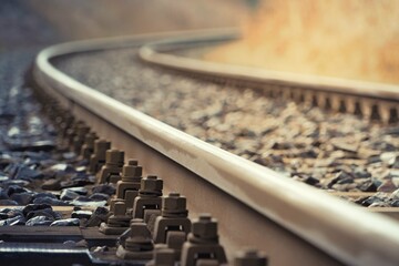 Closeup shot of parallel train track with nuts and bolts