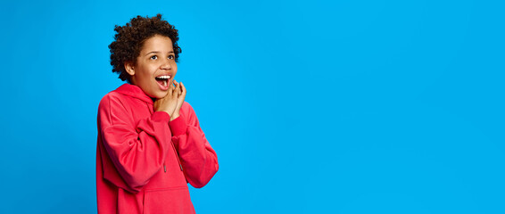 Happiness and excitement moment, African-American girl in pink hoodies expressing happiness and joy...