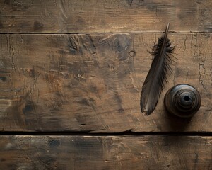 A black feather quill rests on a wooden table next to an ornate inkwell. - obrazy, fototapety, plakaty