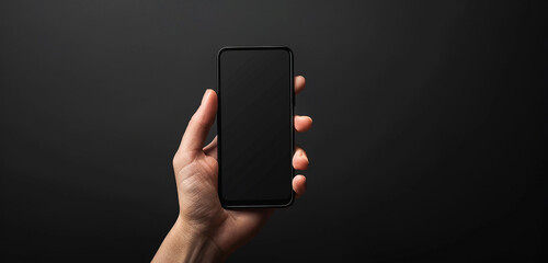 The simplicity and sophistication of a hand holding a blank smartphone screen against a black background, creating a visually stunning and timeless image.