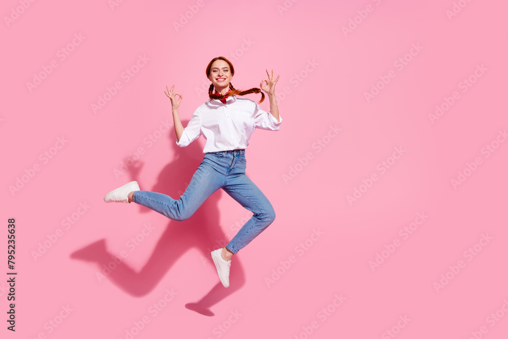 Wall mural full length photo of adorable pretty lady dressed cowboy outfit jumping high showing two okey signs 