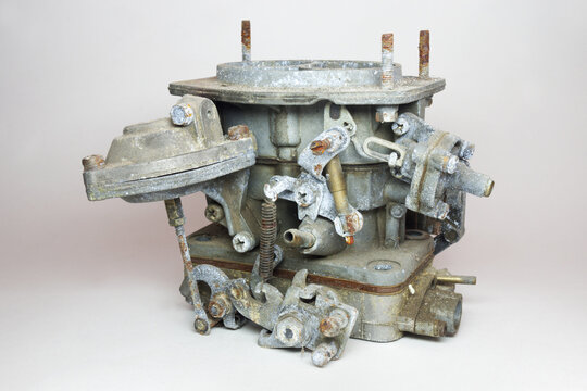 carburator of old car with petrol engine. Showing side of vacuum opening drive of second chamber with telescopic lever, other levers and return spring