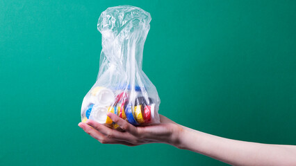 women's hands hold recyclable plastic lids