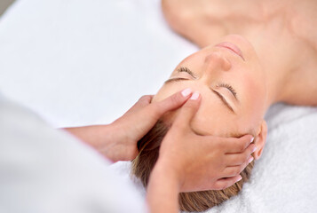 Woman, hands and facial massage or masseuse for treatment, cosmetics and beauty therapy. Female...
