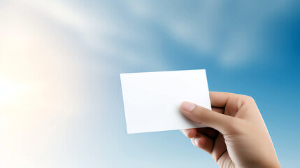 Obraz premium A hand holding a business card against a blurred background