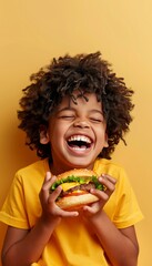 Young boy savoring a delicious hamburger on pastel backdrop with ample room for text placement
