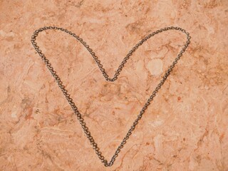 Heart Shaped Necklace on the Floor, Heart Shape Chain in the Sunlight Floor of Marble, Necklace Chain Photography, Isolated Silver Chain Necklace on Marble Floor Jewellery Product Photography
