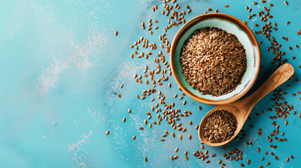Bowl with spoons of flax seeds on color background