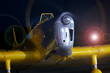 Breighton, Selby, Yorkshire, UK. April 2024. Running vintage propeller aircraft at night.