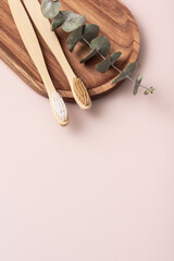 Bamboo toothbrushes on a wooden tray