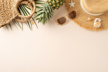 Tropical vibes captured from top view. Straw hat, sunglasses, pineapple, woven bag, beach...