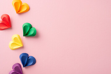 A creative display of multicolored paper hearts in red, yellow, green, and blue, symbolizing...