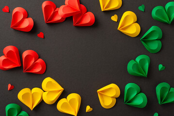 Juneteenth recognition: hearts in red, green, yellow on black surface, marking liberation from...